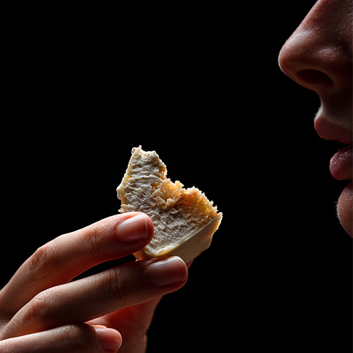 Woman tasting a bite at Dans le Noir ? restaurant
