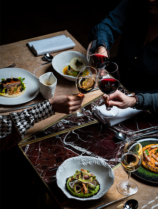 A group of guests celebrating a farewell around a gourmet dinner at Dans le Noir ? restaurant