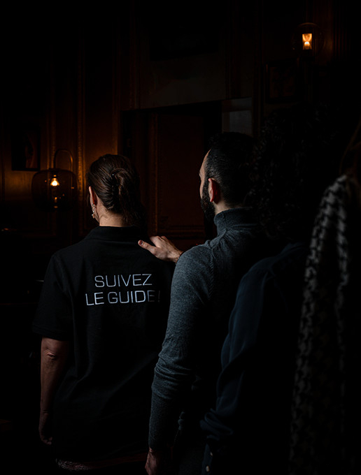 Group in a line celebrating a bachelor party at Dans le Noir ? restaurant